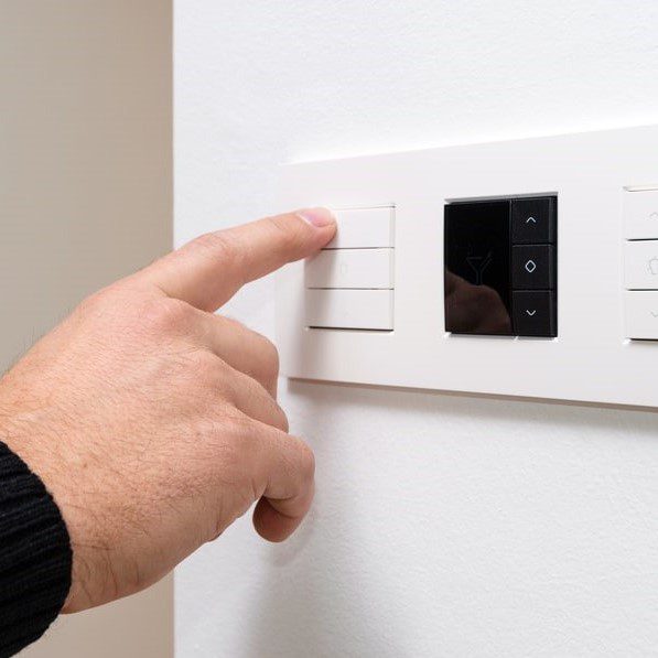 Man using LED dimmer switch
